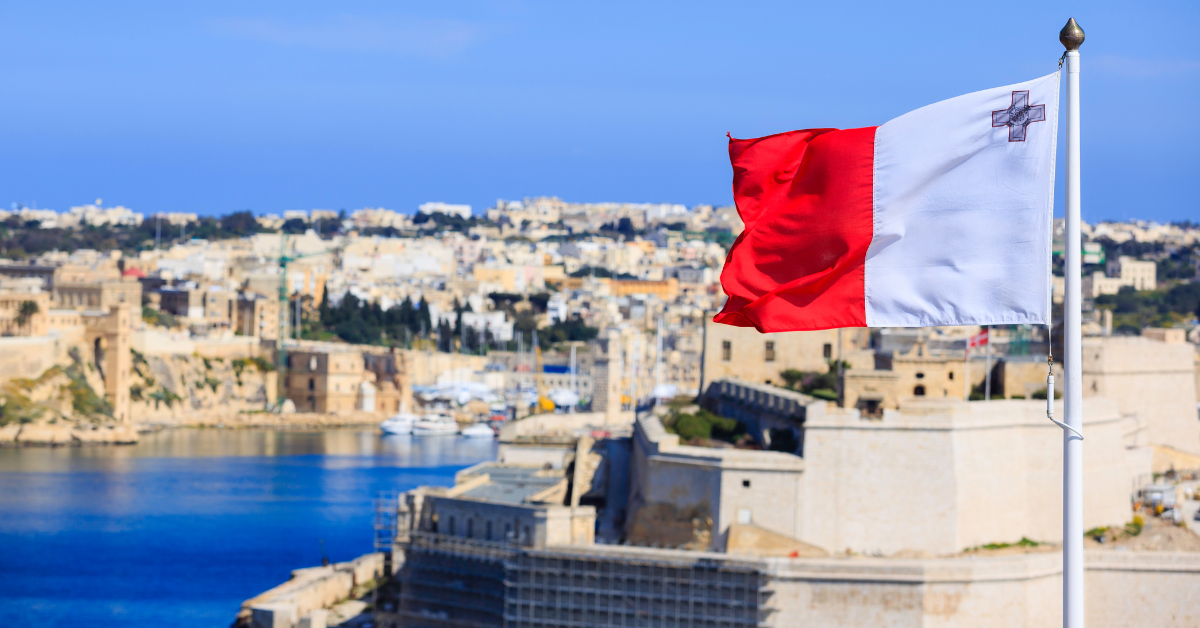 Malta flag overlooking Valletta coastline