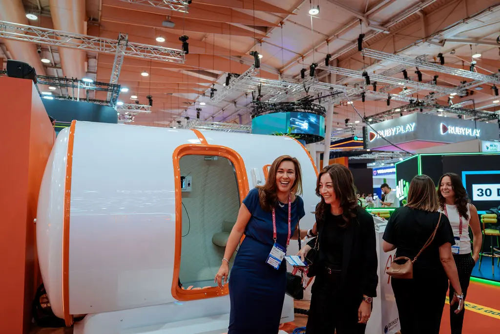 Attendees beside Alea’s hyperbaric chamber at SBC Summit Lisbon 2026.