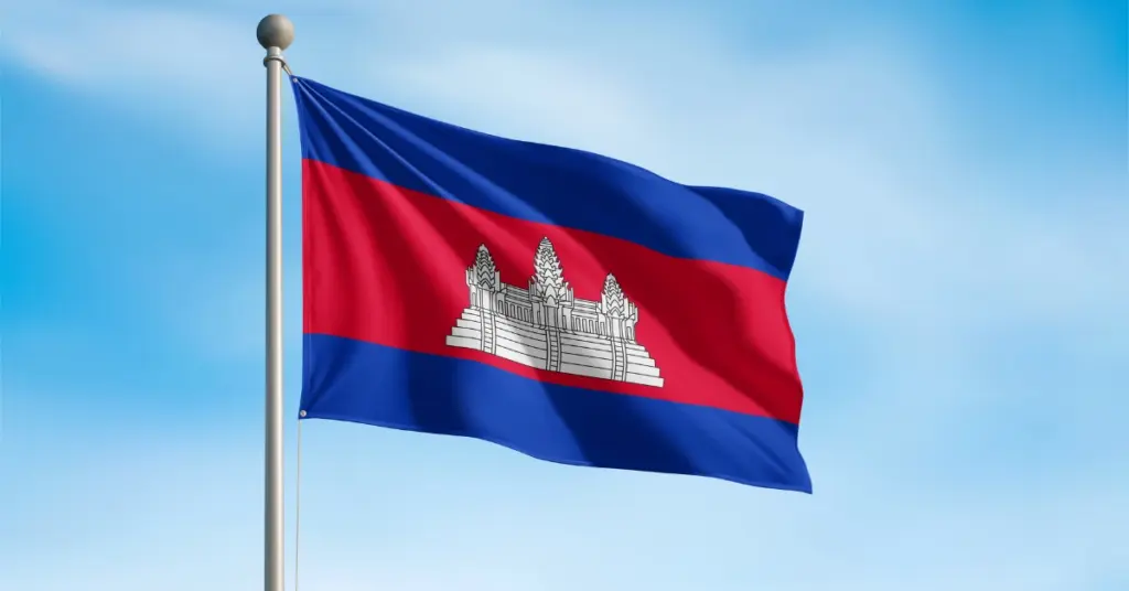 Cambodian national flag waving against a clear blue sky.