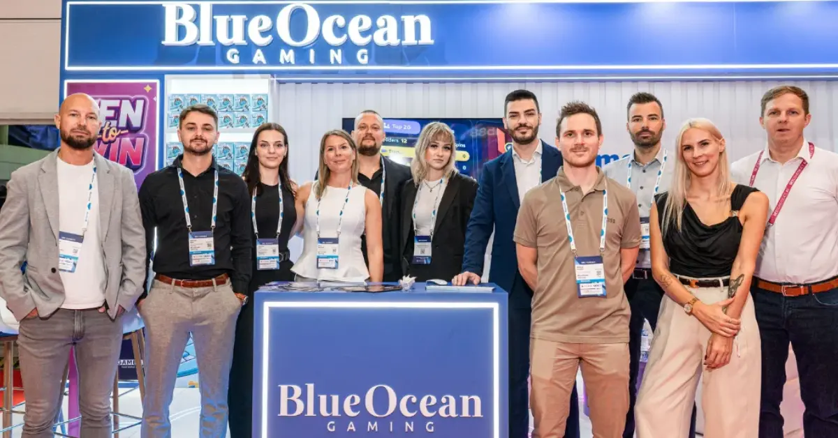 BlueOcean Gaming representatives posing together at their branded gaming exhibition booth.